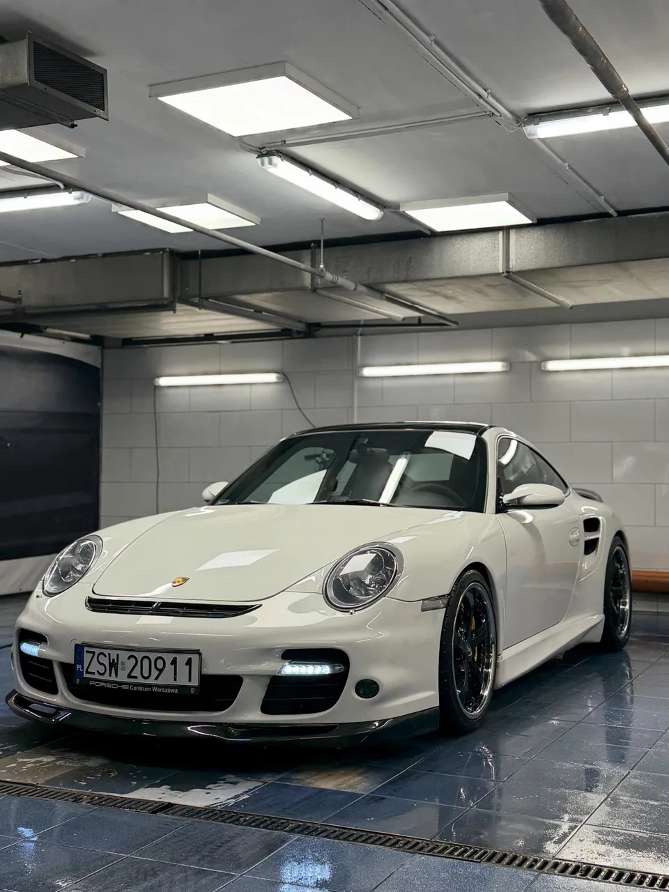 Białe Porsche 911 po myciu w hali PAZIM
